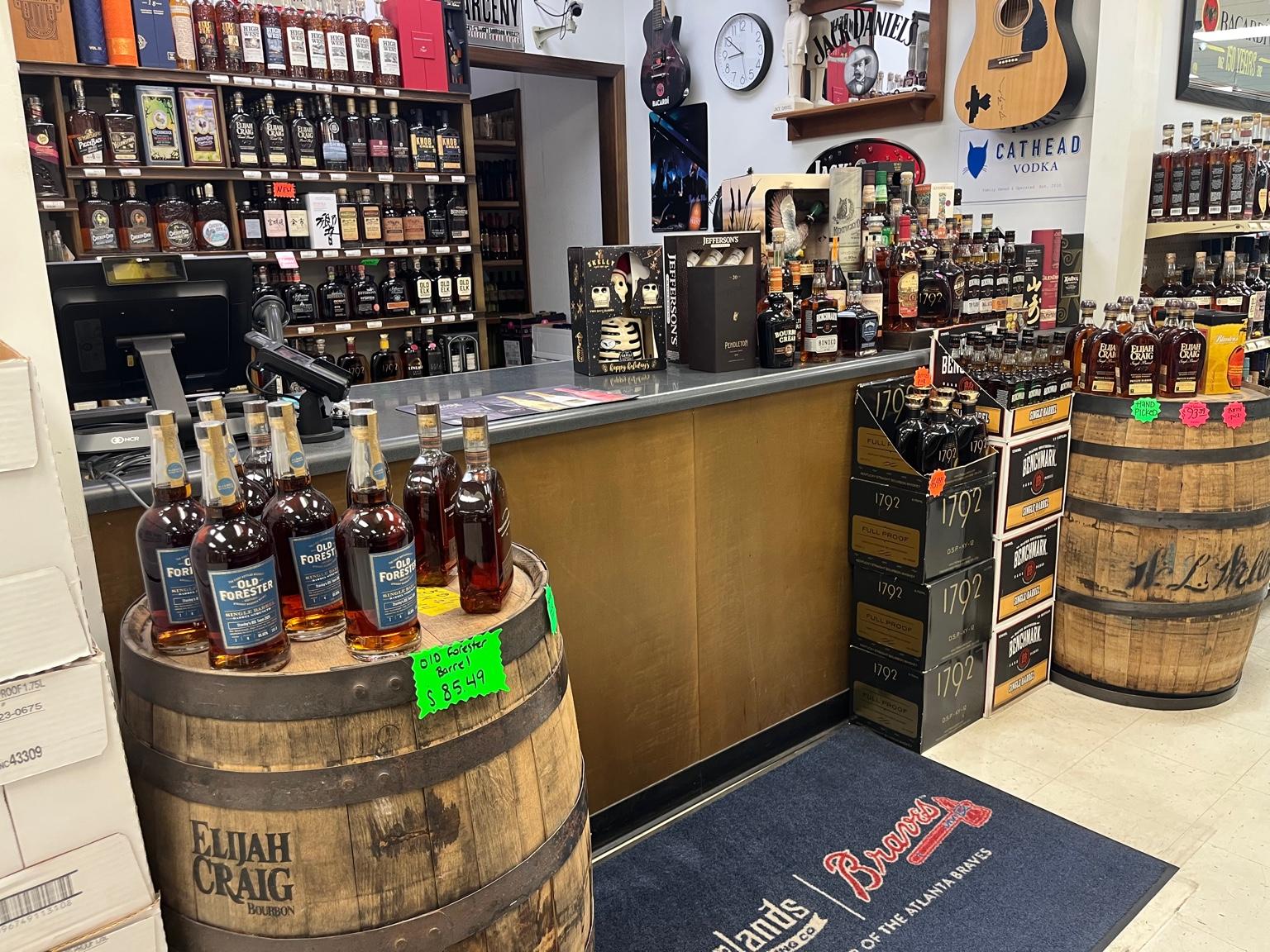 Bourbon display and whiskey barrels inside Stanley's Liquor & Wine in Jackson