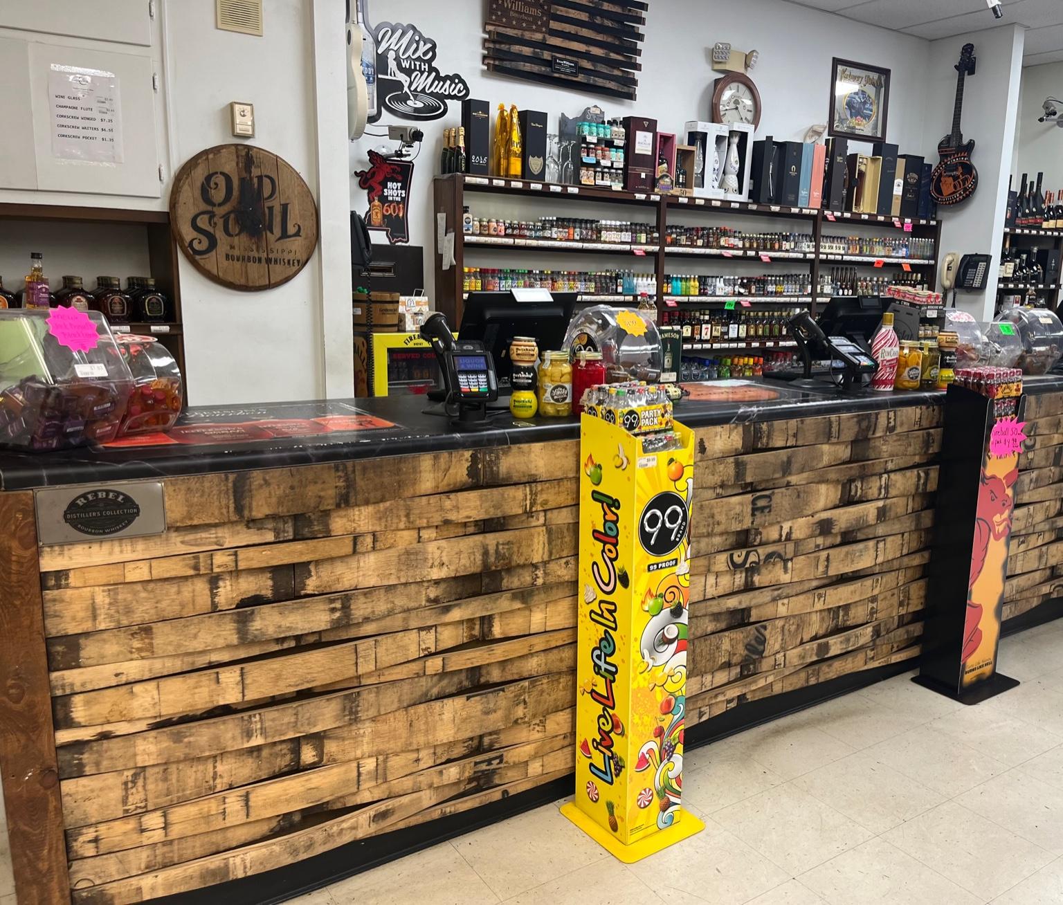 Checkout counter with shelves of spirits inside Stanley's Liquor & Wine in Jackson